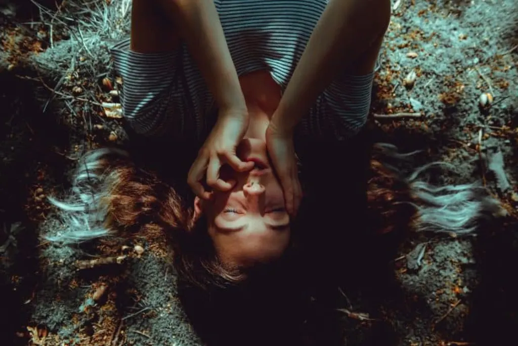 Woman lying on ground